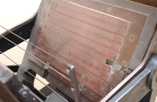 Braille plates attached to the steel and cast iron printing press