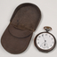 Brown case holding pocket watch with Braille markings