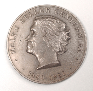 Silver coin with profile of short-haired woman turned to the left