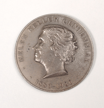 Silver coin with profile of short-haired woman turned to the left