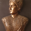 Mounted sculpture showing head and shoulders profile of Tilly Aston.