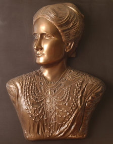 Mounted sculpture showing head and shoulders profile of Tilly Aston.