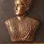 Mounted sculpture showing head and shoulders profile of Tilly Aston.