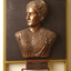 Mounted sculpture showing head and shoulders profile of Tilly Aston.