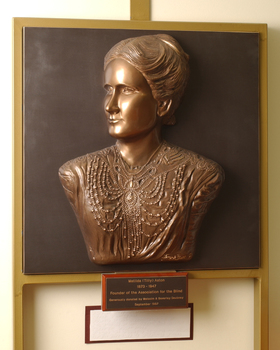 Mounted sculpture showing head and shoulders profile of Tilly Aston.