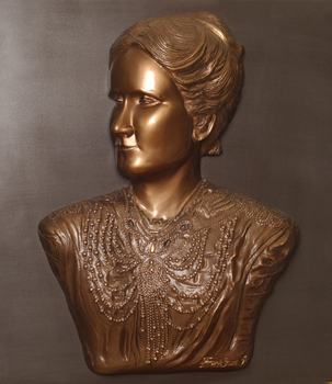 Mounted sculpture showing head and shoulders profile of Tilly Aston.