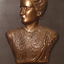Mounted sculpture showing head and shoulders profile of Tilly Aston.