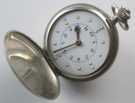 Opened watch with braille markers and numbers on watch face