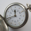 Opened watch with braille markers and numbers on watch face
