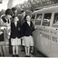 Two cast members with three school children on pavement outside theatre, standing next to RVIB combi