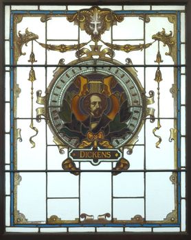 Three animals holding a shield featuring an image of Charles Dickens