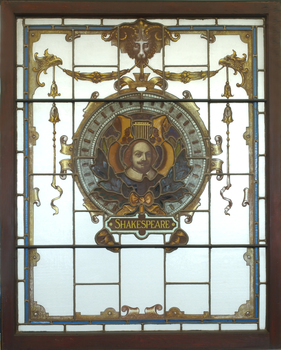 Three animals holding a shield featuring an image of William Shakespeare