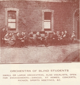 Group of musicians sits outside entrance to RVIB building with instruments in hand