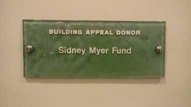 Stippled green tinted glass plaques with names.