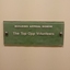Stippled green tinted glass plaques with names.