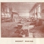Men standing behind their stations in the basket making workshop