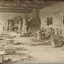 Men sitting on hessian making cane baskets inside a workshop