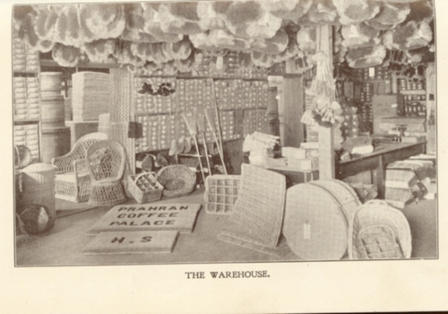 Cane baskets hang over counter, lining walls and on the floor with mats in display