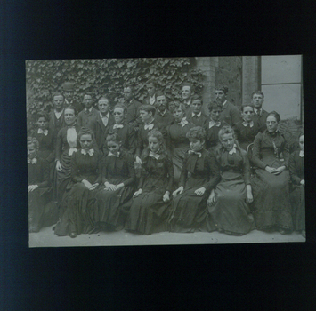 Group of women and men dressed in dark clothing near entrance to RVIB building