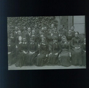Group of women and men dressed in dark clothing near entrance to RVIB building