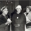 Mrs Tutton at the microphone with a line of woman approaching her