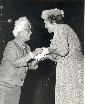 Mrs Tutton handing a badge (?) to an auxiliary member