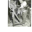 Man feeding millet stalks into binder