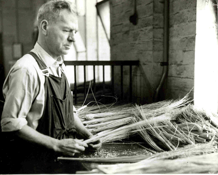 Man holding strands of millet