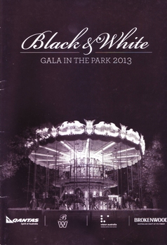 Black and white photograph of carousel in park lit up at night