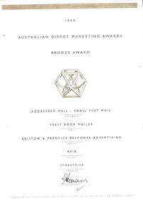 Cream paper with bronze line at top and multi-facet shape with black writing