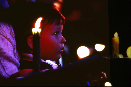 Boy sitting in a lap facing stage
