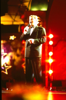 Denis Walter singing on stage