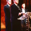 Two CEOs speak whilst Ray Martin stands by
