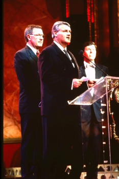 Two CEOs speak whilst Ray Martin stands by