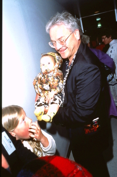 Dr Nikolai Jeuniewic holds baby Lexie backstage (?)