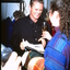 Male performer given a glass of wine backstage