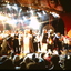 On stage at the conclusion of the night, performers covered in streamers