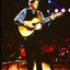 Tommy Emmanuel playing on stage at Carols