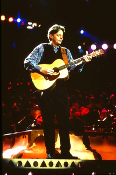 Tommy Emmanuel playing on stage at Carols