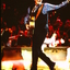 Tommy Emmanuel walking on stage waving to the crowd