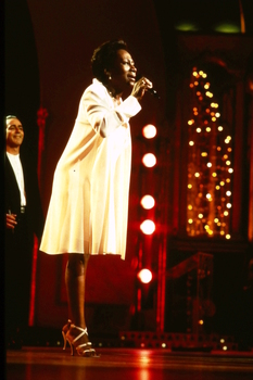 Venetta Fields singing on stage whilst Lyndsay Field looks on