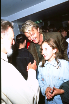 Peter Cupples watches Geoff Harvey speak to a young girl (possibly his daughter)