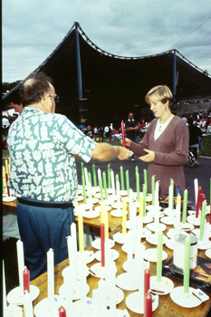 A woman buying candles from the stall