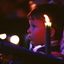 Boy looking toward stage with candles around him