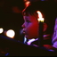 Boy looking toward stage with candles around him