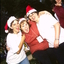 Three woman in Santa hats having fun