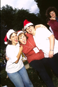 Three woman in Santa hats having fun