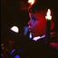 Boy looking at stage with candles around him
