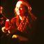Girl holding candle and wearing Santa hat
