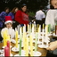 People buying candles at stall 